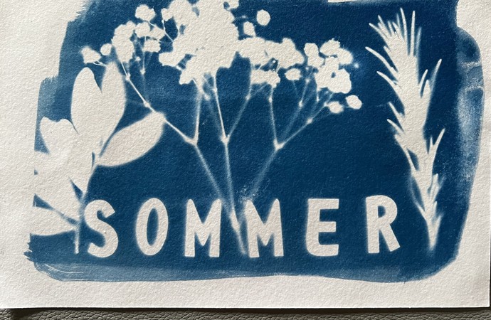 Beispiel einer Postkarte mit Blaudruck. Sie zeigt Blumenumrisse und das Wort "Sommer".