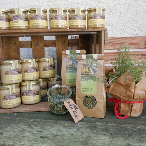 Honig und Tee aus dem Dalheimer Klosterladen werden auf einem Holztisch präsentiert.