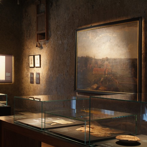 Foto aus der ehemaligen Räucherkammer mit Exponaten und einem Gemälde.